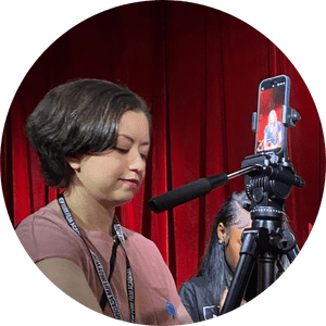 Laura setting up a tripod for a college short video